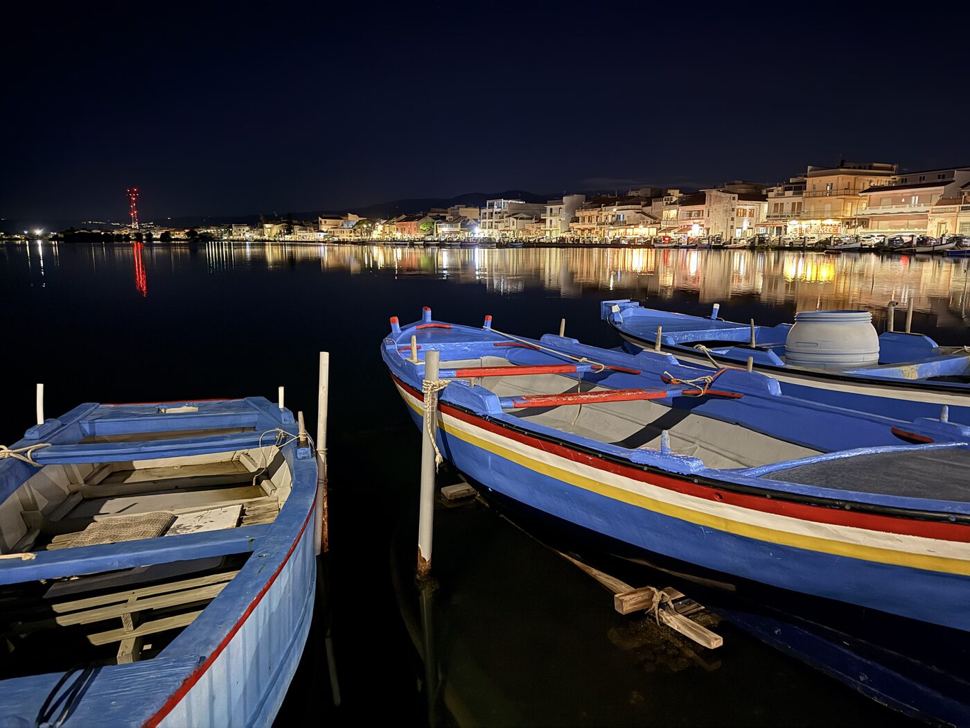 Colorful small boats in a harbor at night