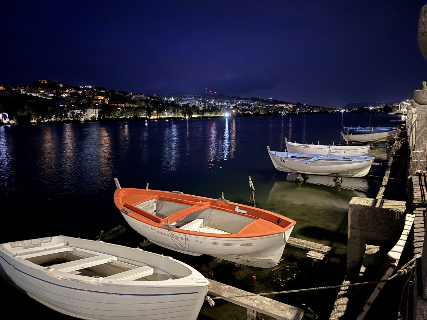 Small boats along the coast after dark