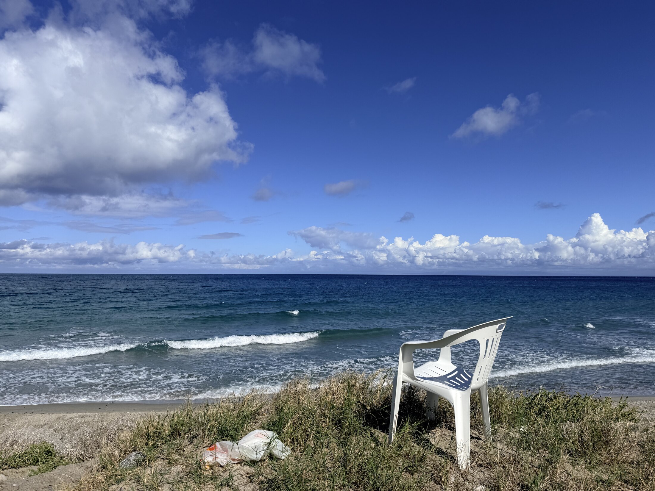 A solitary chair overlooking the blue sea